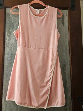 Sleeveless Pink Large Tennis Dress Features A Wrap-Style Overlay Covering Sorts